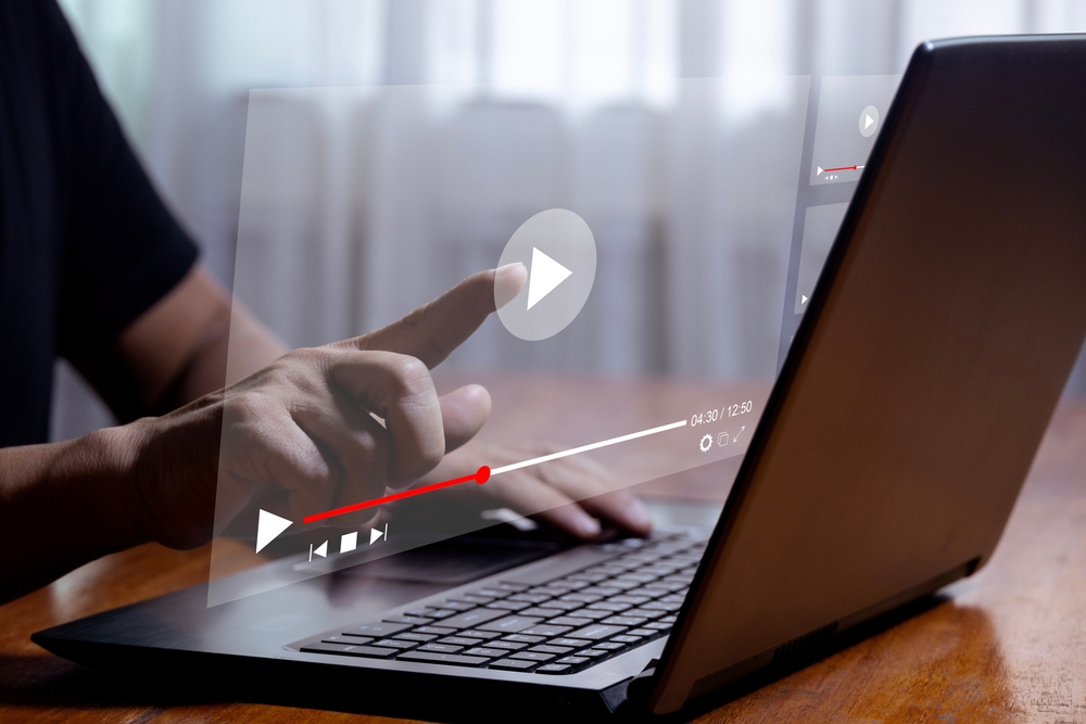 Man,using,laptop,to,stream,online,on,virtual,screen,streaming